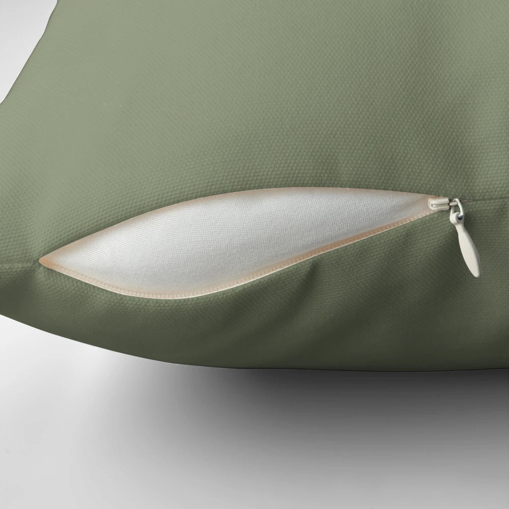 Sage green pillow with a soft, solid color design