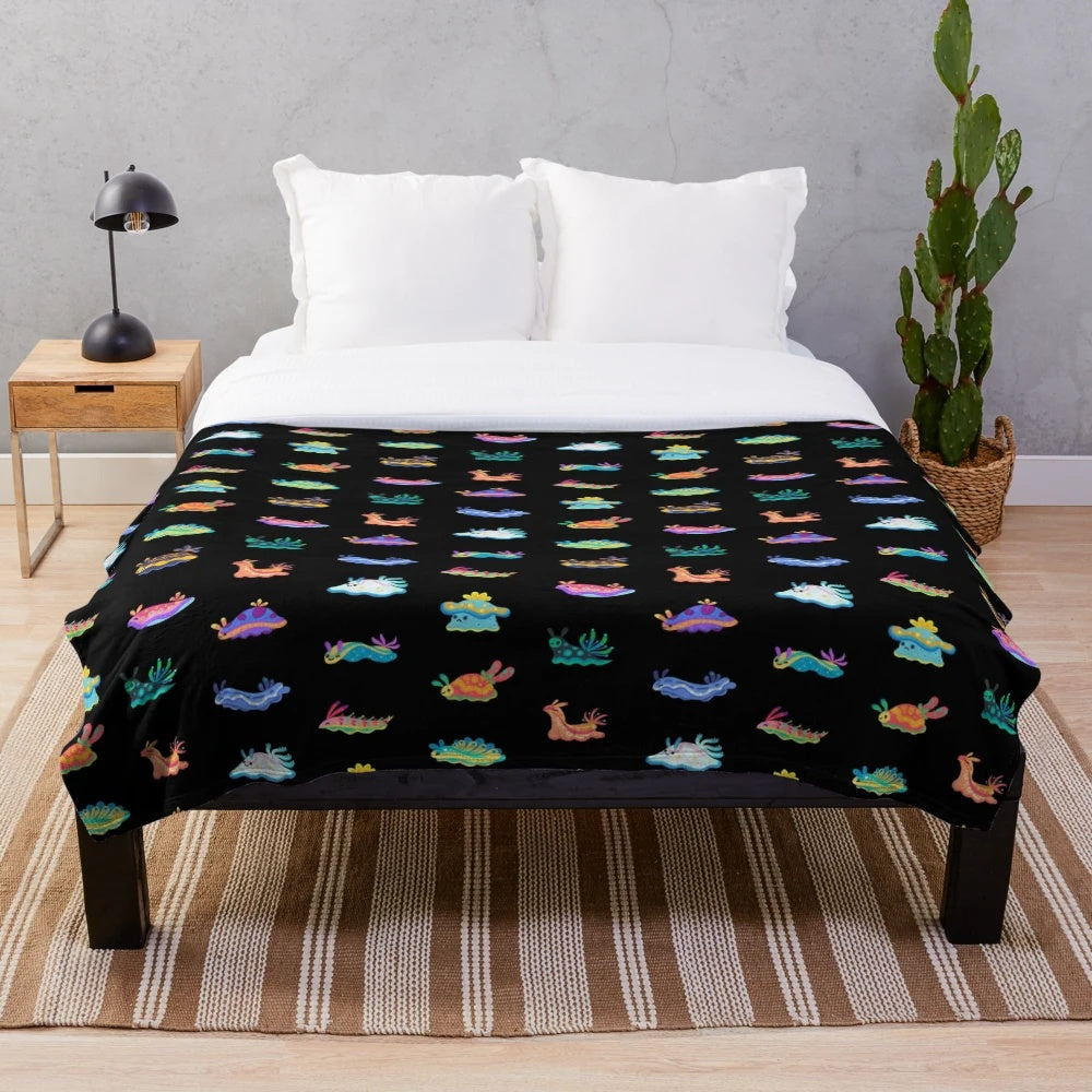 Black plush blanket featuring a detailed sea slug or nudibranch design
