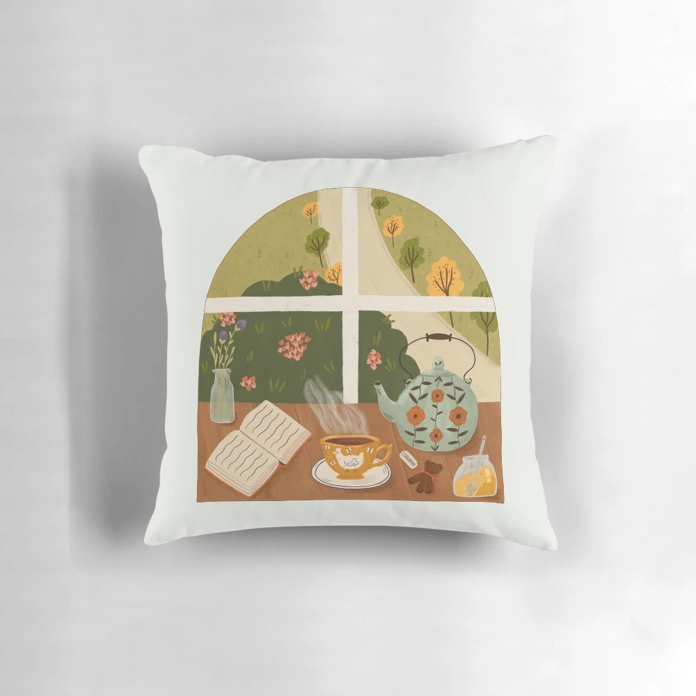 A cozy tea time pillow featuring a teapot, teacup, and books on a cottage-style windowsill.