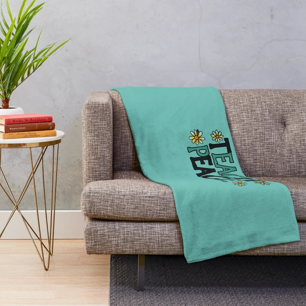 Soft plush blanket with "Teach Peace" design, perfect for educational settings and home decor.
