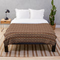 Plush blanket featuring a geometric pattern of indigenous trees