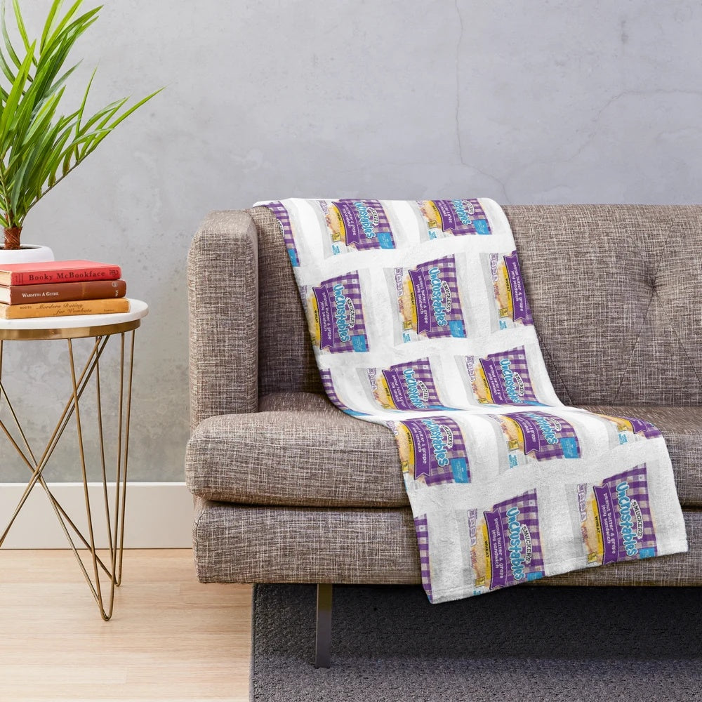 Uncrustables-inspired plush blanket with peanut butter and grape jelly design
