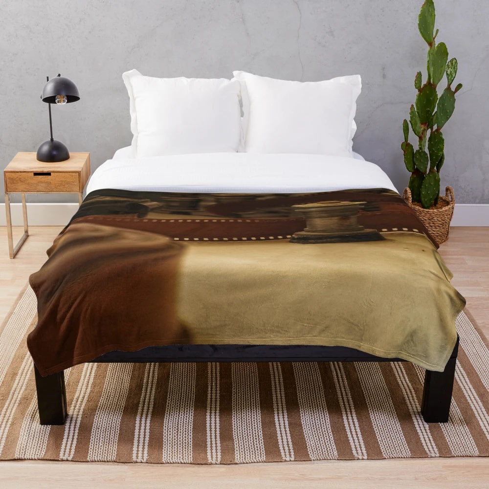 Vintage cinema-inspired plush blanket with retro camera and movie projector elements