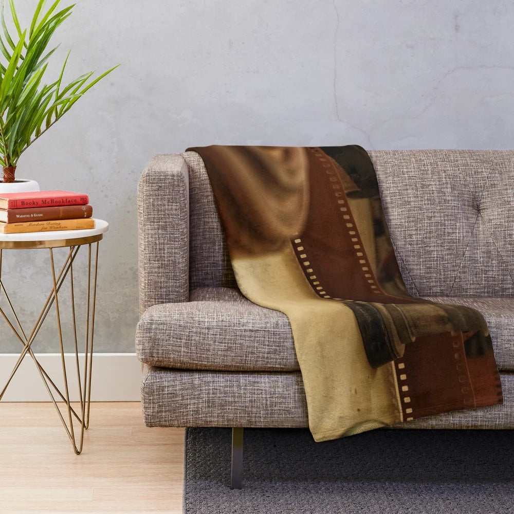 Vintage cinema-inspired plush blanket with retro camera and movie projector elements