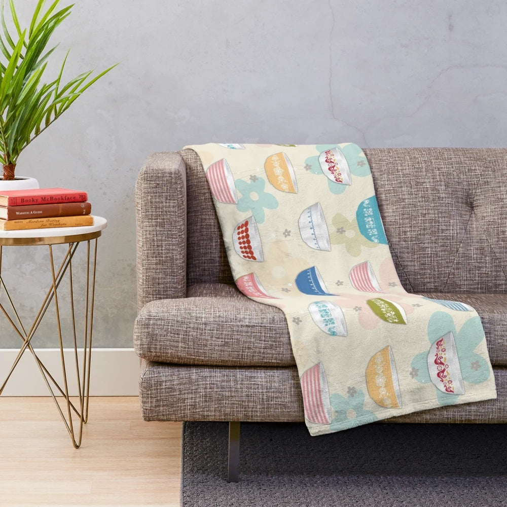 Vintage-inspired plush blanket featuring a collage of iconic Pyrex bowl designs