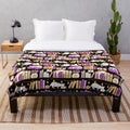 Violet plush blanket with a cute cat design, perfect for a cozy reading nook