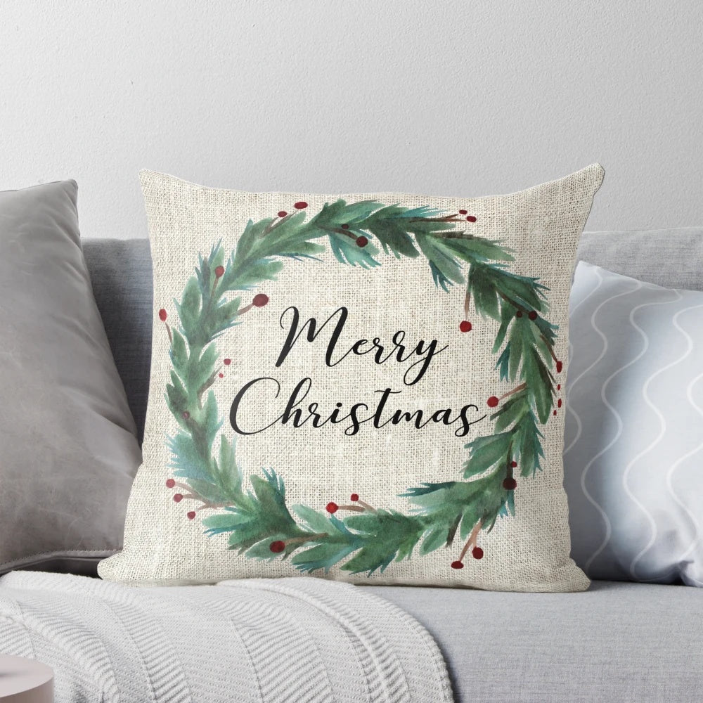 A watercolor-style Christmas wreath printed on a soft, plush pillow.