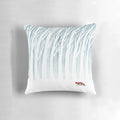 A plush, decorative pillow featuring a winter forest scene with a fox, branches, and snow.
