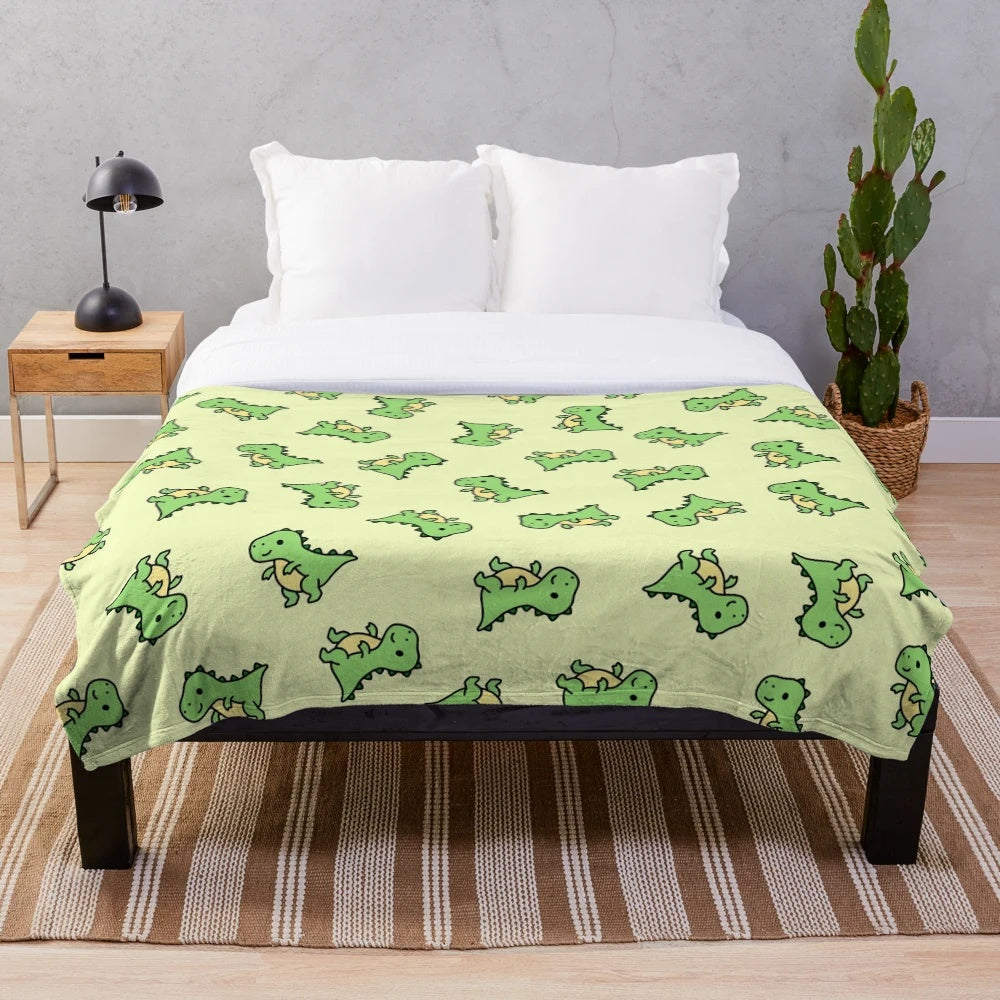 Cuddly T. Rex plush blanket with a green and teal color scheme