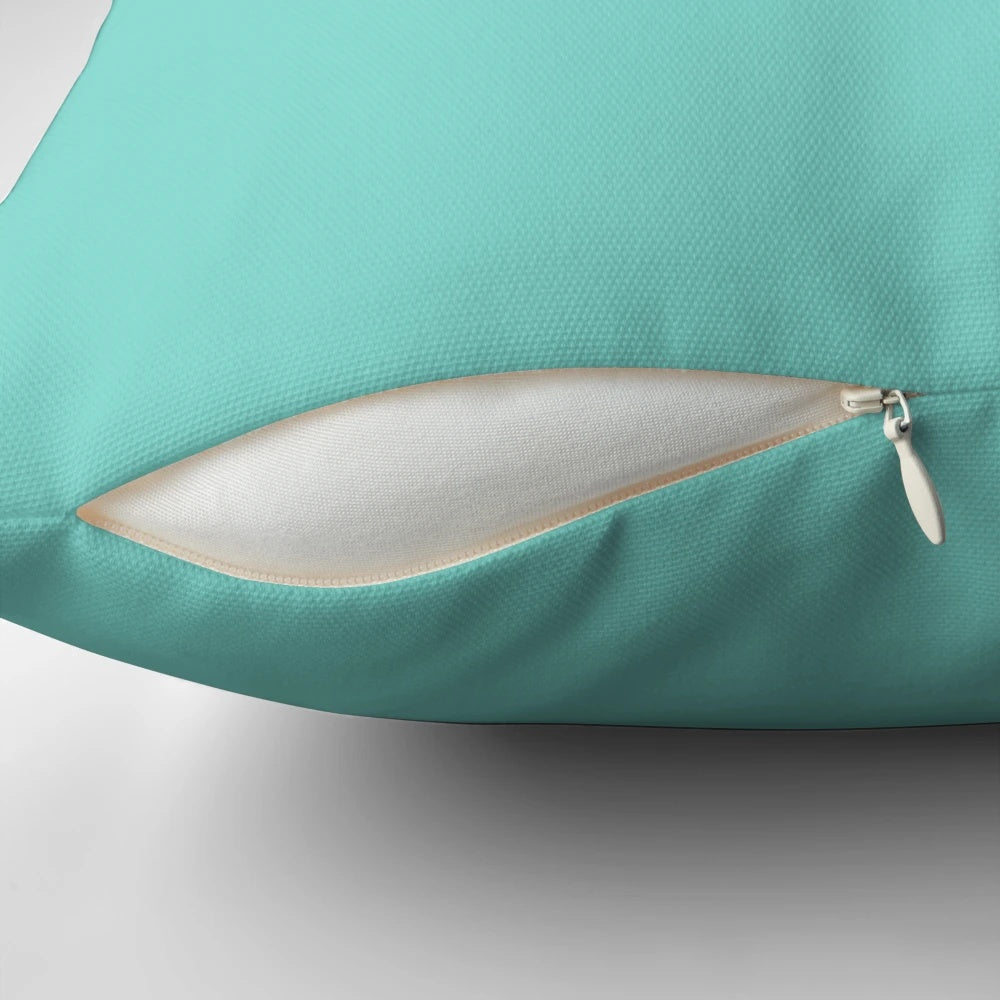 Decorative throw pillow with a diamond-inspired design in shades of blue and white.