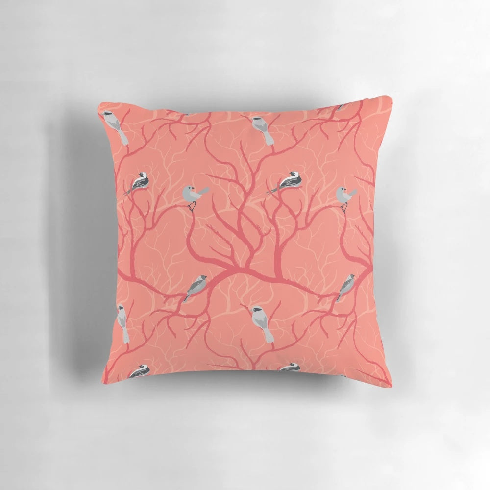 Decorative coral pillow with a beautiful birds design, perfect for adding a touch of nature-inspired style to any bedroom.