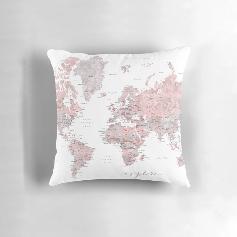 Detailed pink watercolor world map printed on a plush, decorative pillow