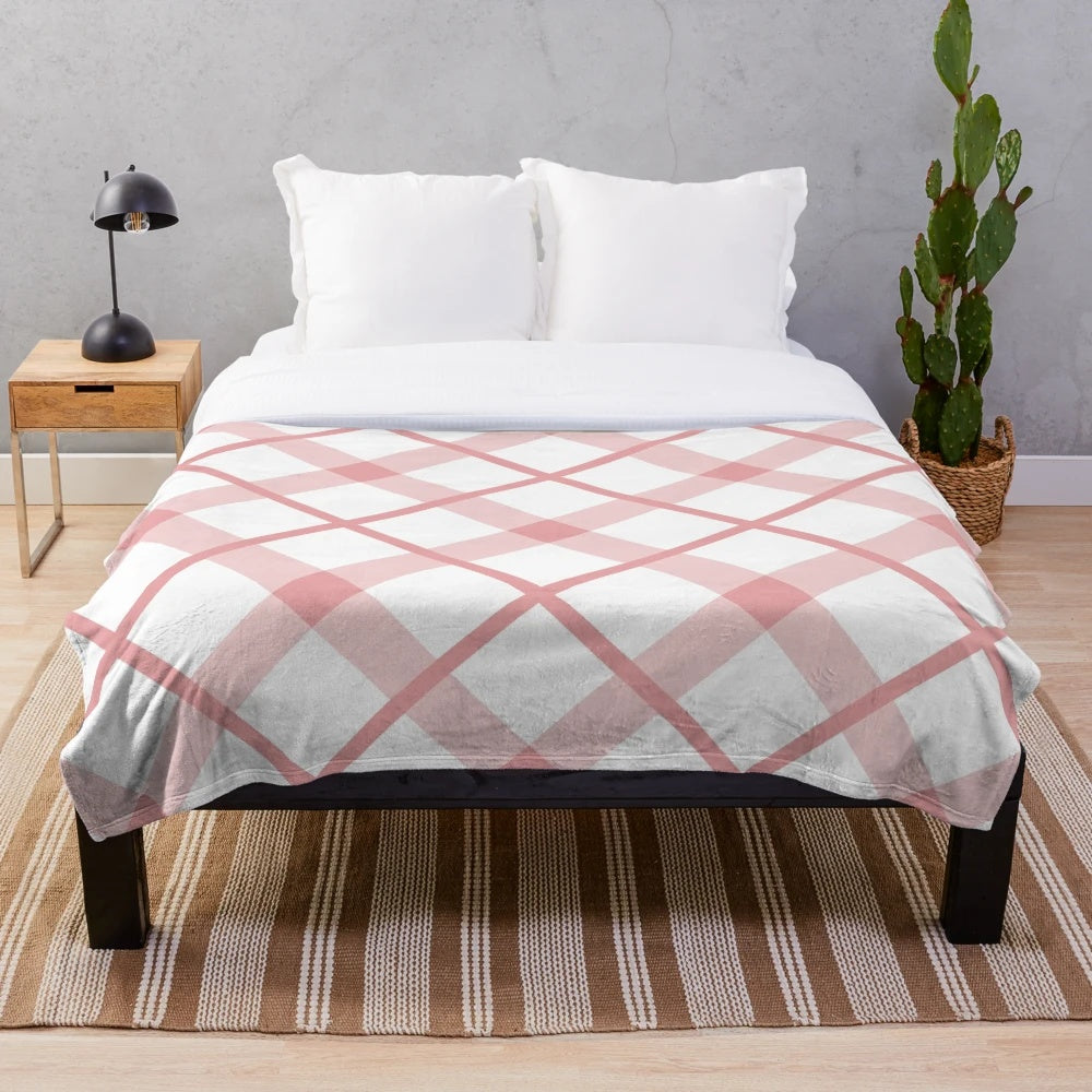 Diagonal plaid patterned plush blanket in pink