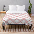 Diagonal plaid patterned plush blanket in pink