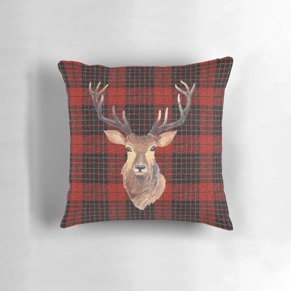 Closeup portrait of a majestic Highland stag with impressive antlers against a tartan background