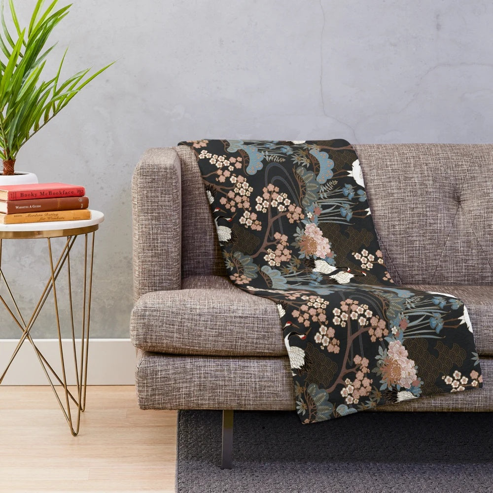 Japanese garden-inspired dark plush blanket with delicate white cranes and cherry blossoms