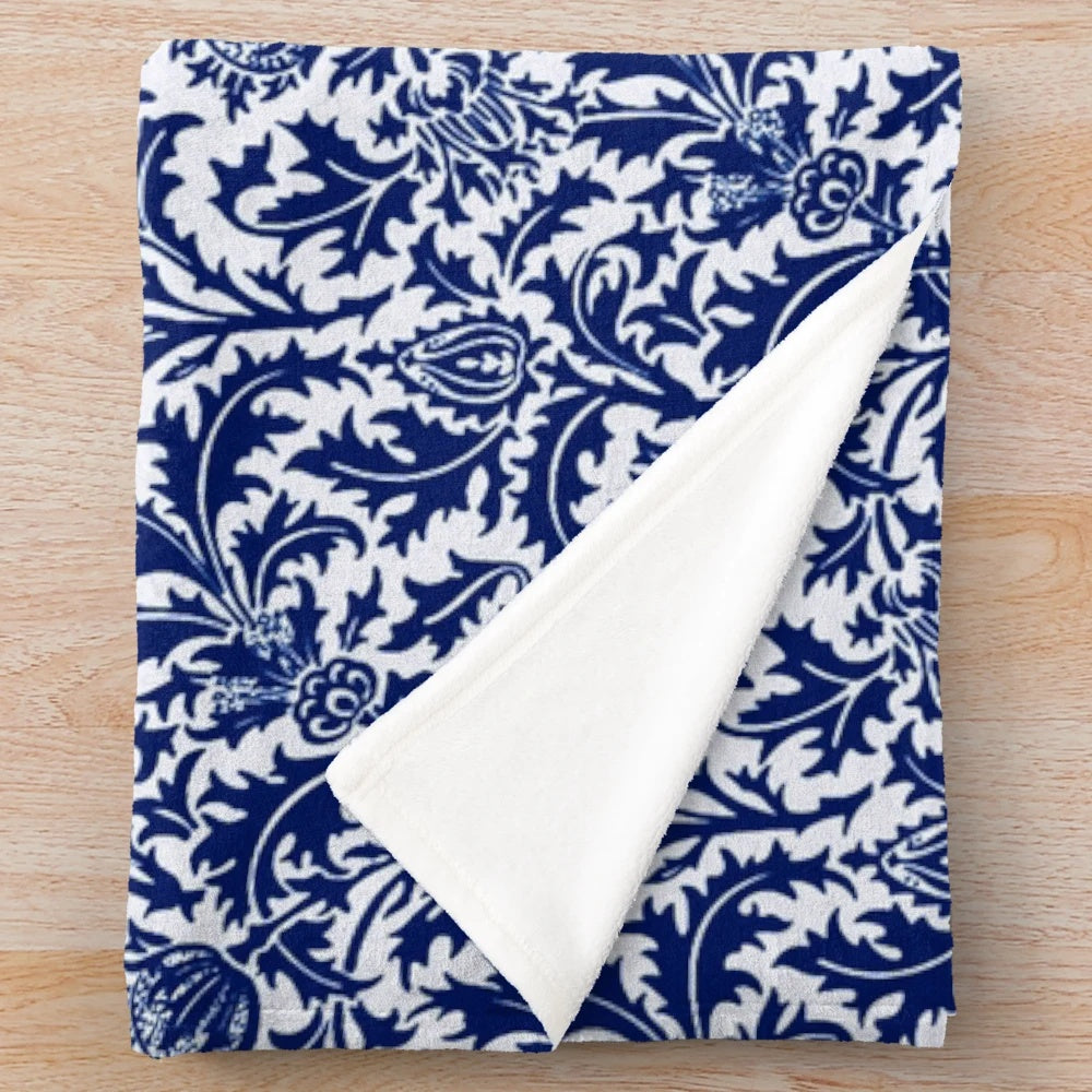 Vintage-inspired navy blue and white plush blanket featuring a damask thistle floral design in the William Morris art nouveau style.
