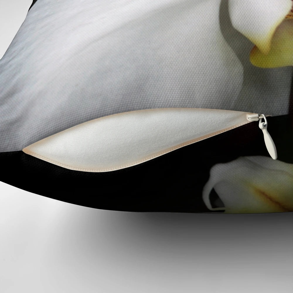 Close-up image of a beautiful white orchid flower on a decorative pillow