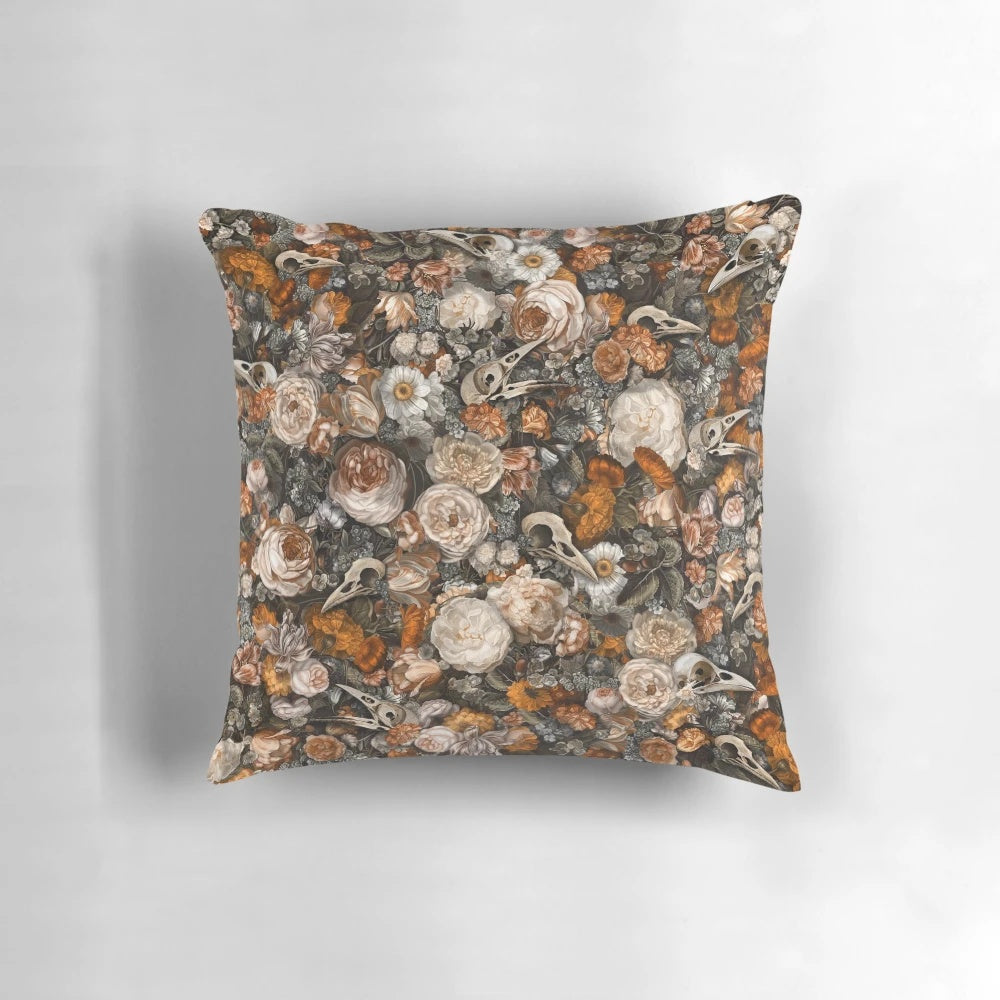 Ornate baroque-style pillow with a macabre skull and bird design, featuring a vintage floral pattern in rich, autumnal colors.