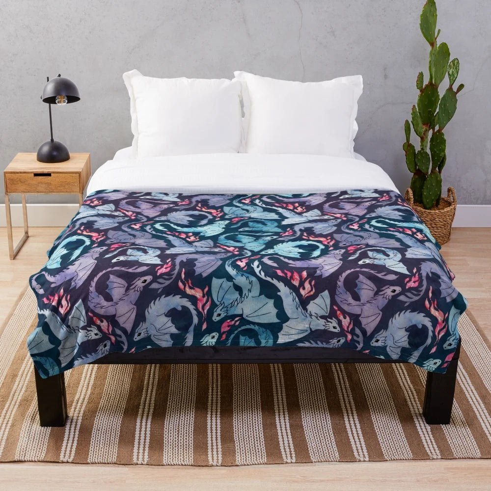 Plush blanket featuring a whimsical dragon design in shades of turquoise and purple