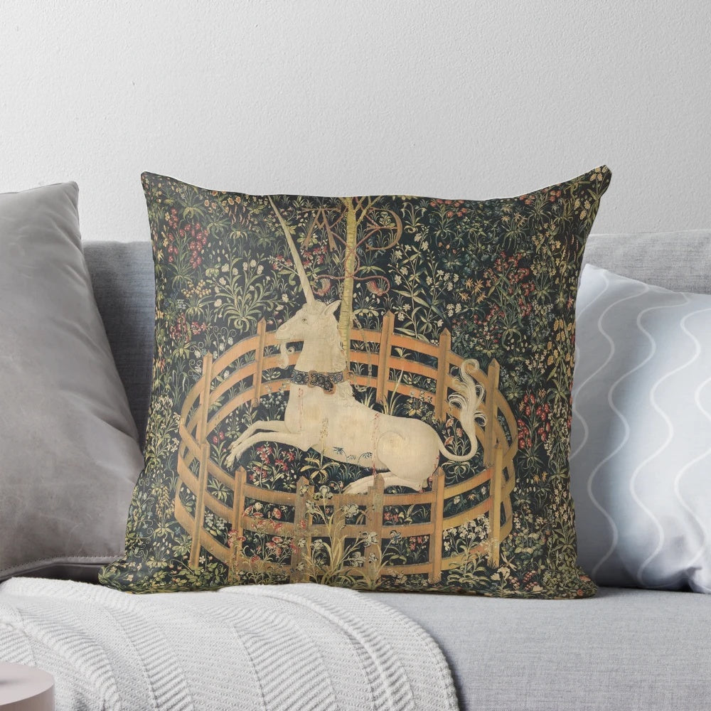 A medieval-inspired tapestry-style pillow featuring a mythical unicorn in a lush, floral setting.