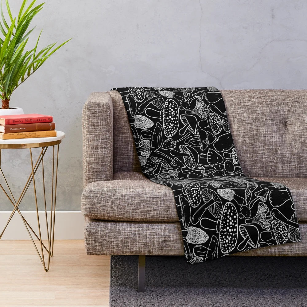 Plush blanket with an allover mushroom and fungus pattern