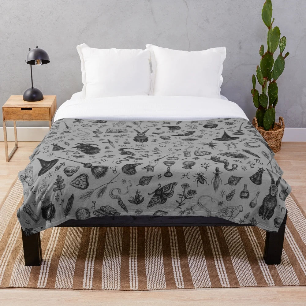 Salem witch plush blanket with rabbit, snake, and crow motifs