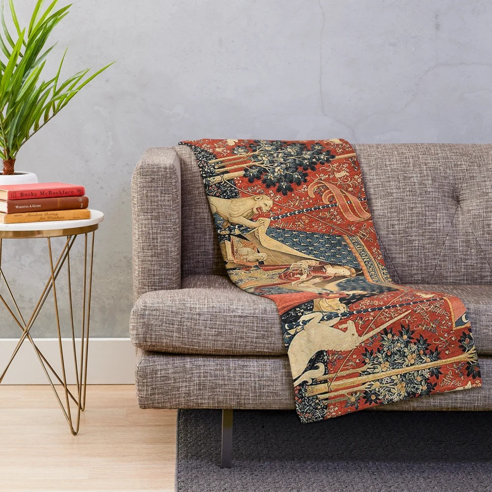 The Lady and the Unicorn plush blanket featuring a mythological unicorn and floral design