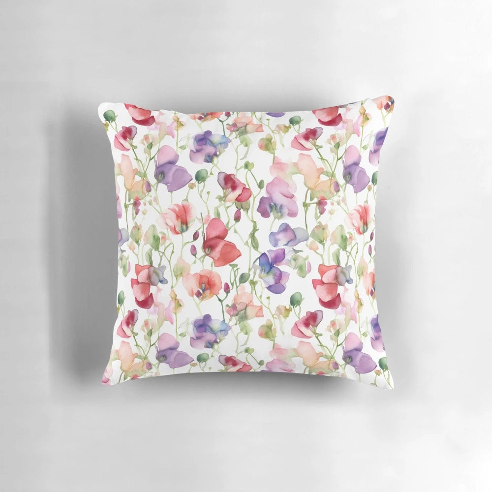 A decorative throw pillow featuring a beautiful watercolor painting of sweet pea flowers.