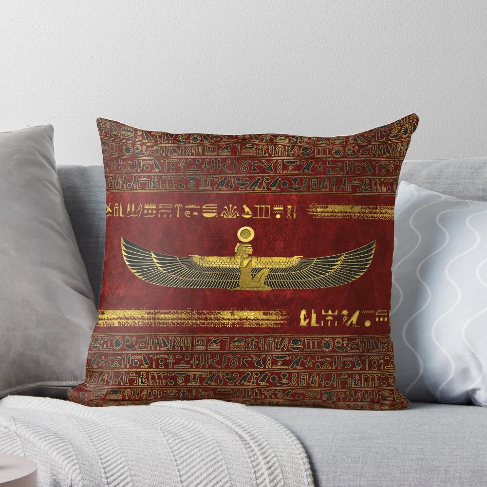 Golden Egyptian god ornament on a rich, red leather pillow