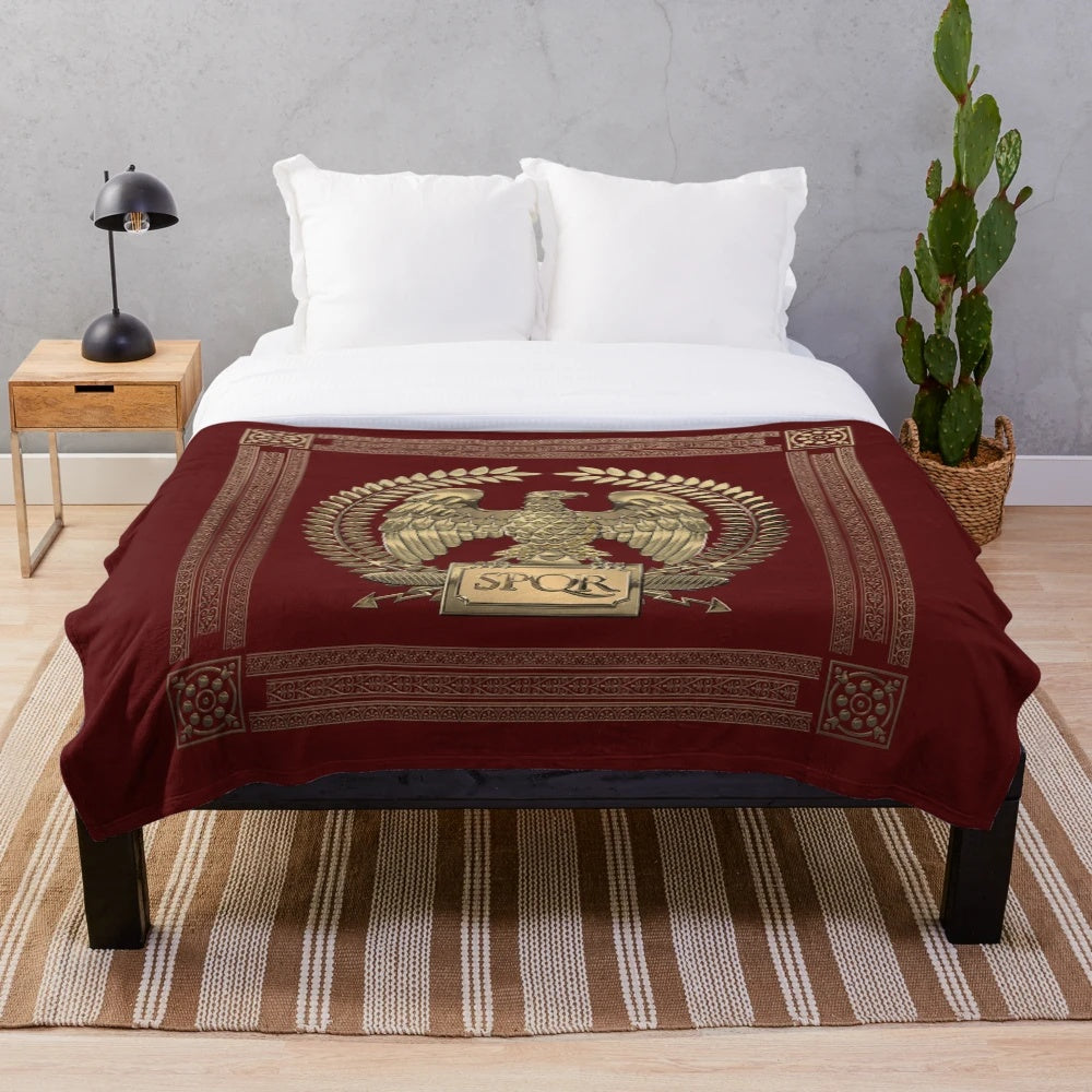 Plush blanket featuring the Roman Empire's iconic gold imperial eagle emblem on a rich red velvet backdrop