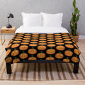 Cozy orange pumpkin plush blanket with carved jack-o-lantern face