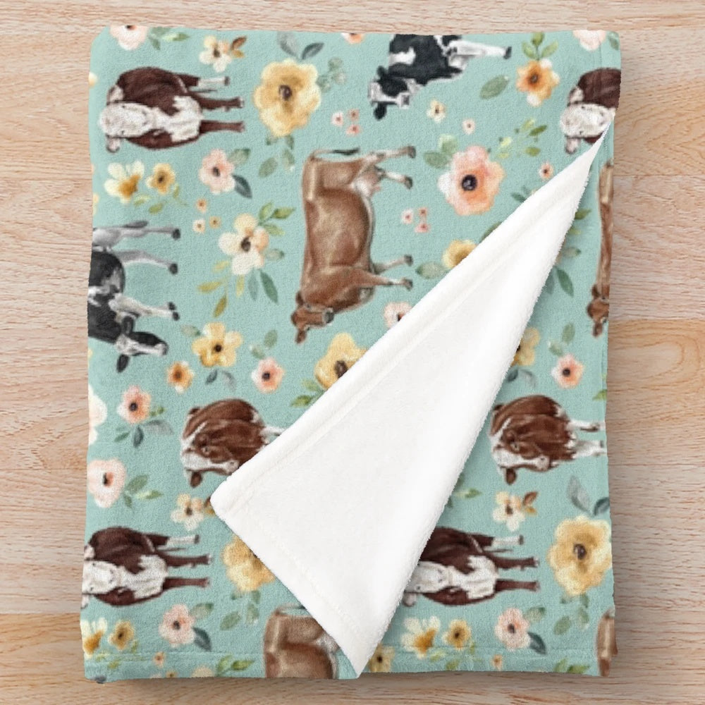 Plush cow blanket with floral watercolor design
