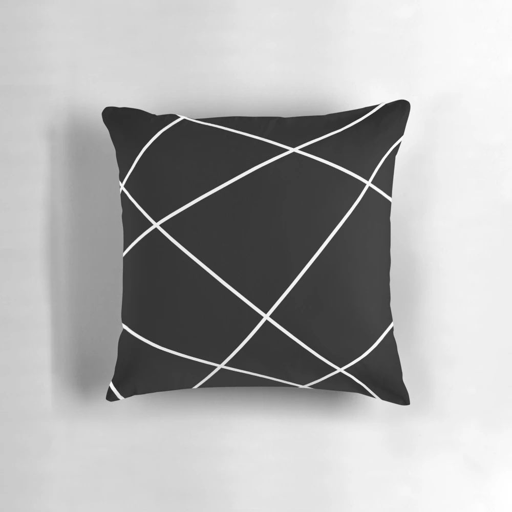Geometric abstract throw pillow in black and white design, modern minimalist home accent.