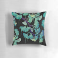 Artistic watercolor painting of ginkgo leaves on a black background, printed on a decorative throw pillow.