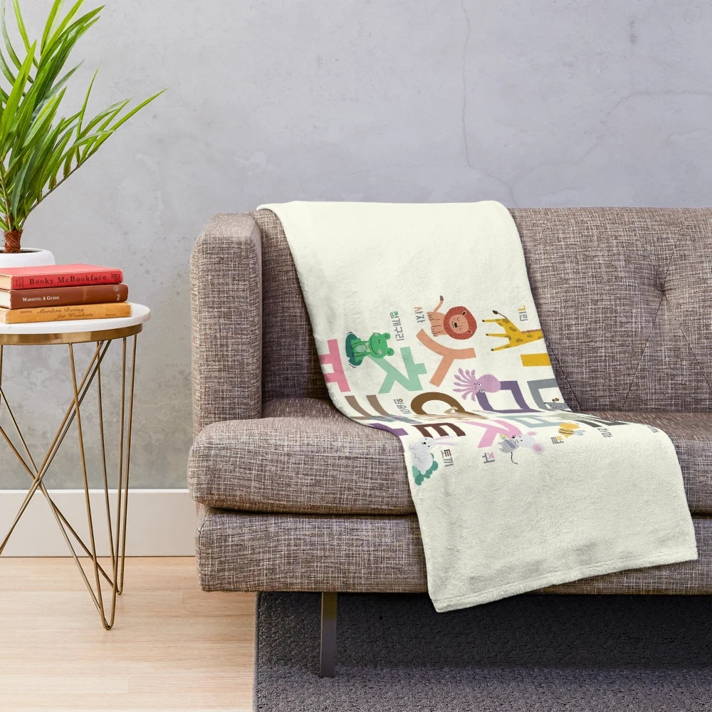 Plush blanket featuring hand-drawn illustrations of Korean alphabet and cute animals