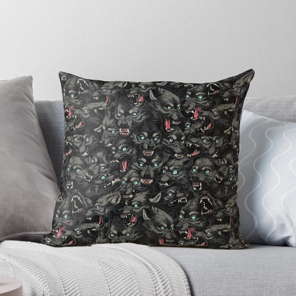 A grey and black wolf pack pattern pillow with snarling timber wolves