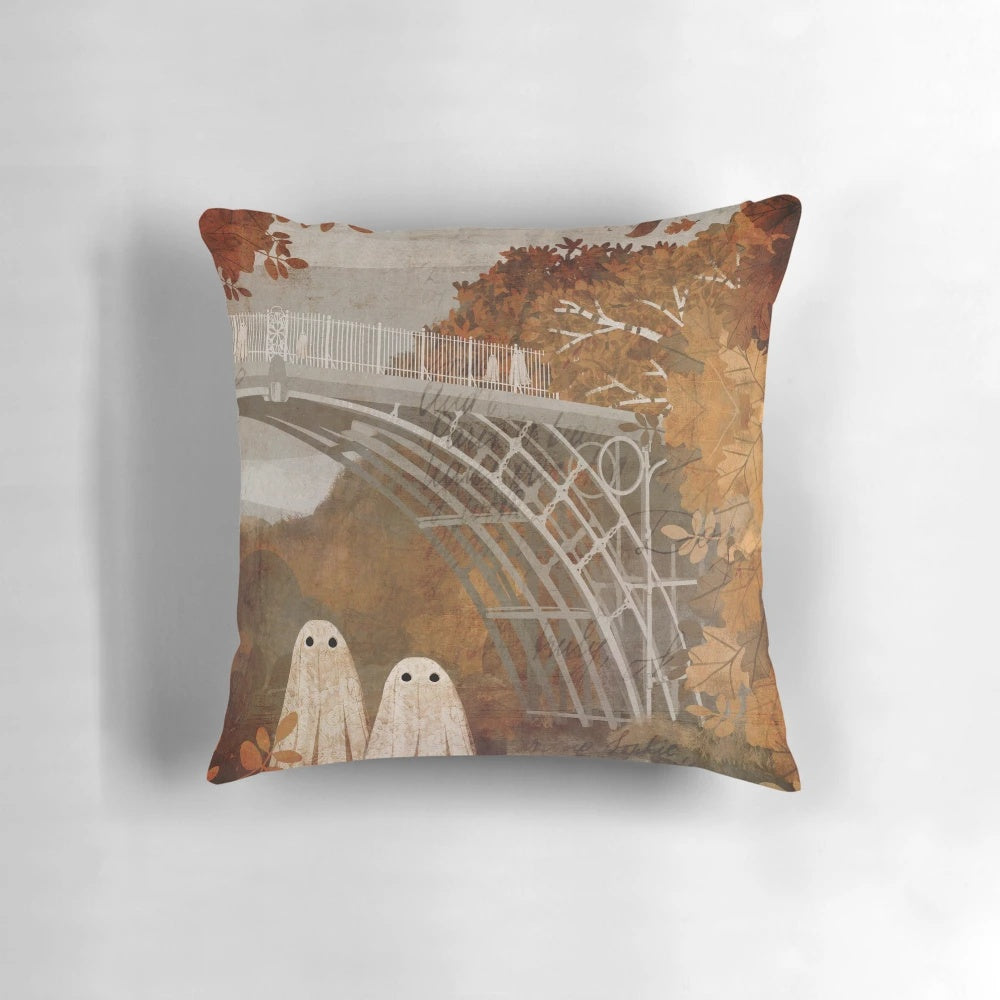 Vintage-inspired pillow featuring a haunted bridge in an autumn landscape