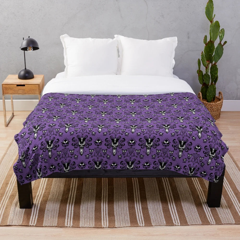 Haunted mansion plush blanket featuring gothic inspired wallpaper design