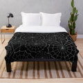 Spider web patterned plush blanket for spooky home decor