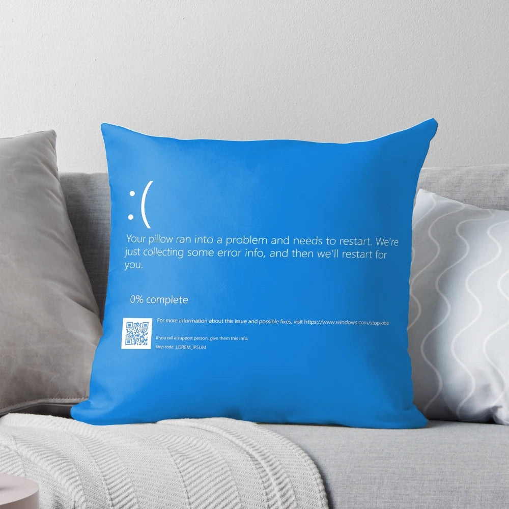Decorative pillow featuring a playful "Blue Screen of Death" design, a nod to the iconic Windows computer error.