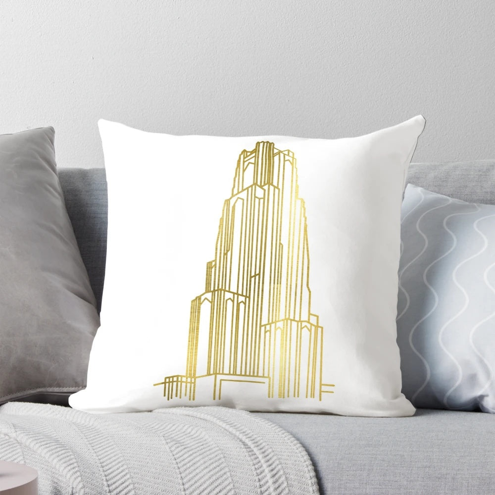 Close-up image of a gold-colored decorative pillow featuring the Cathedral of Learning, a renowned landmark at the University of Pittsburgh.