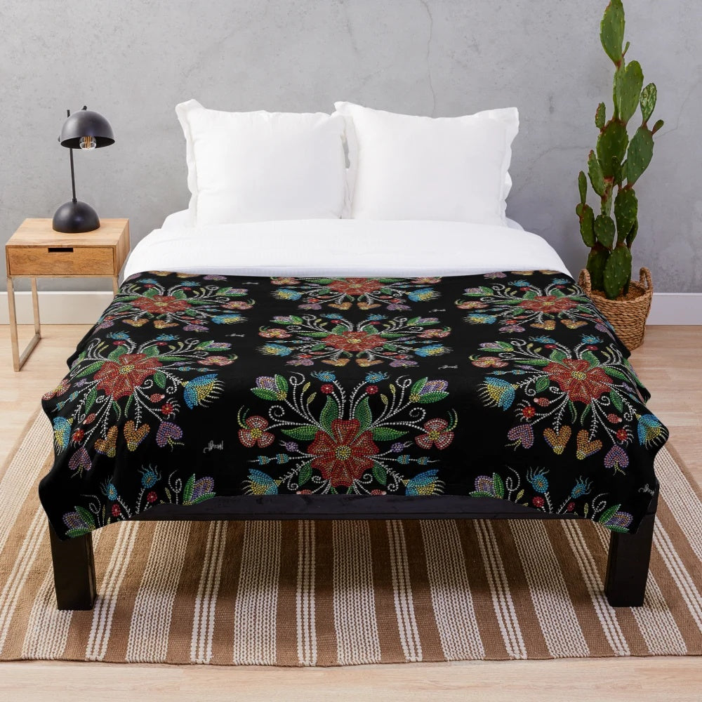 Indigenous-inspired plush blanket with beadwork and dot patterns