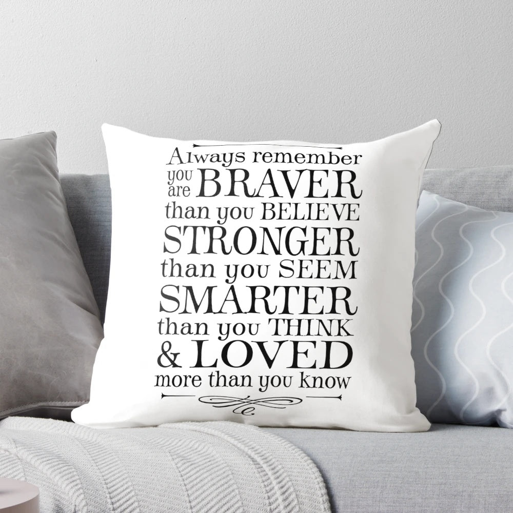 Black and white throw pillow with the text "You are braver than you believe" in a stylized font.
