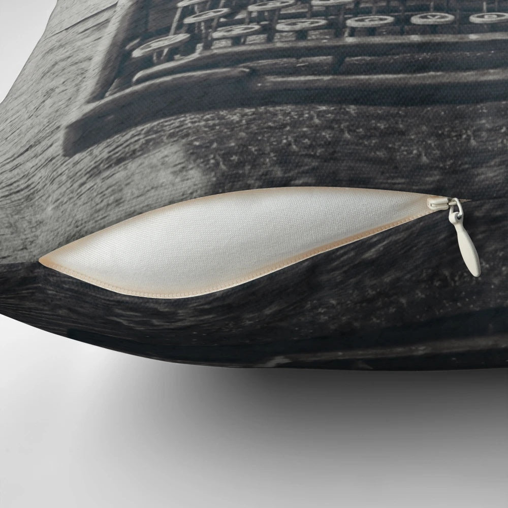A black and white pillow featuring a vintage typewriter and an inspirational quote about writing by author Stephen King
