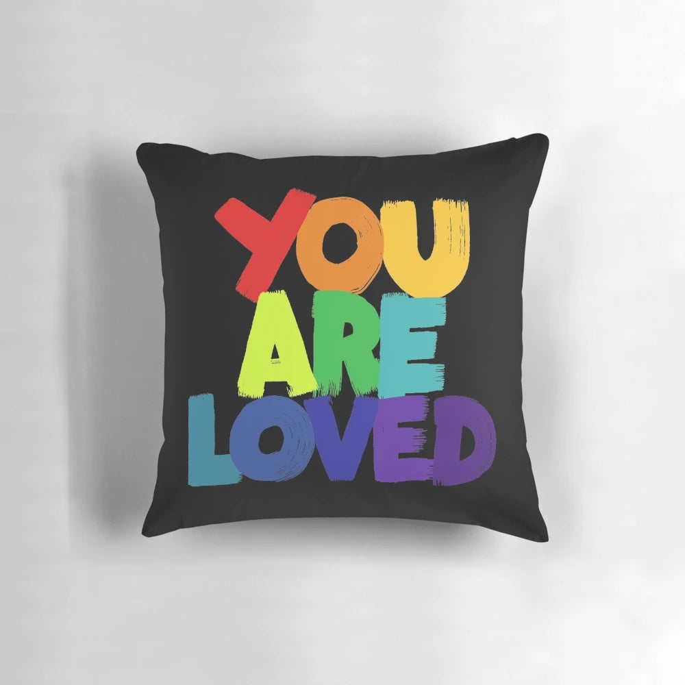 Colorful 'You Are Loved' typography pillow with rainbow lettering