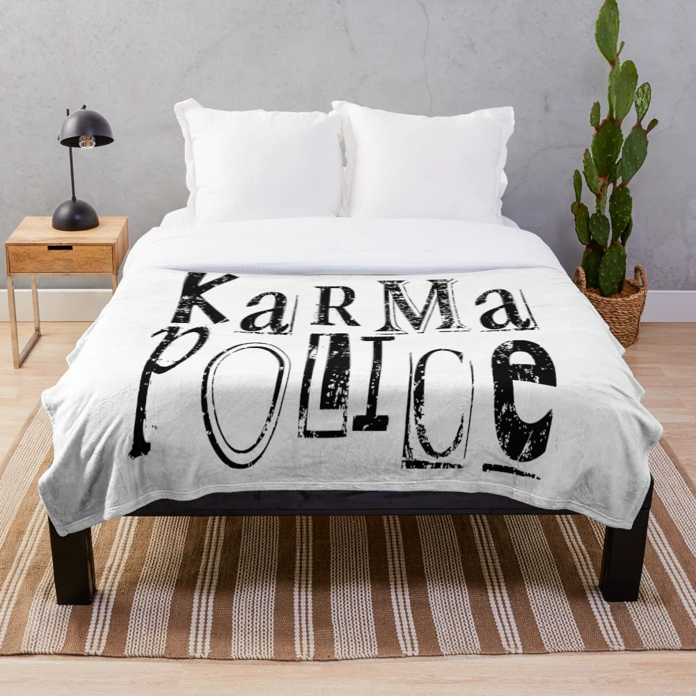 Karma Police themed plush blanket with band graphics and lyrics