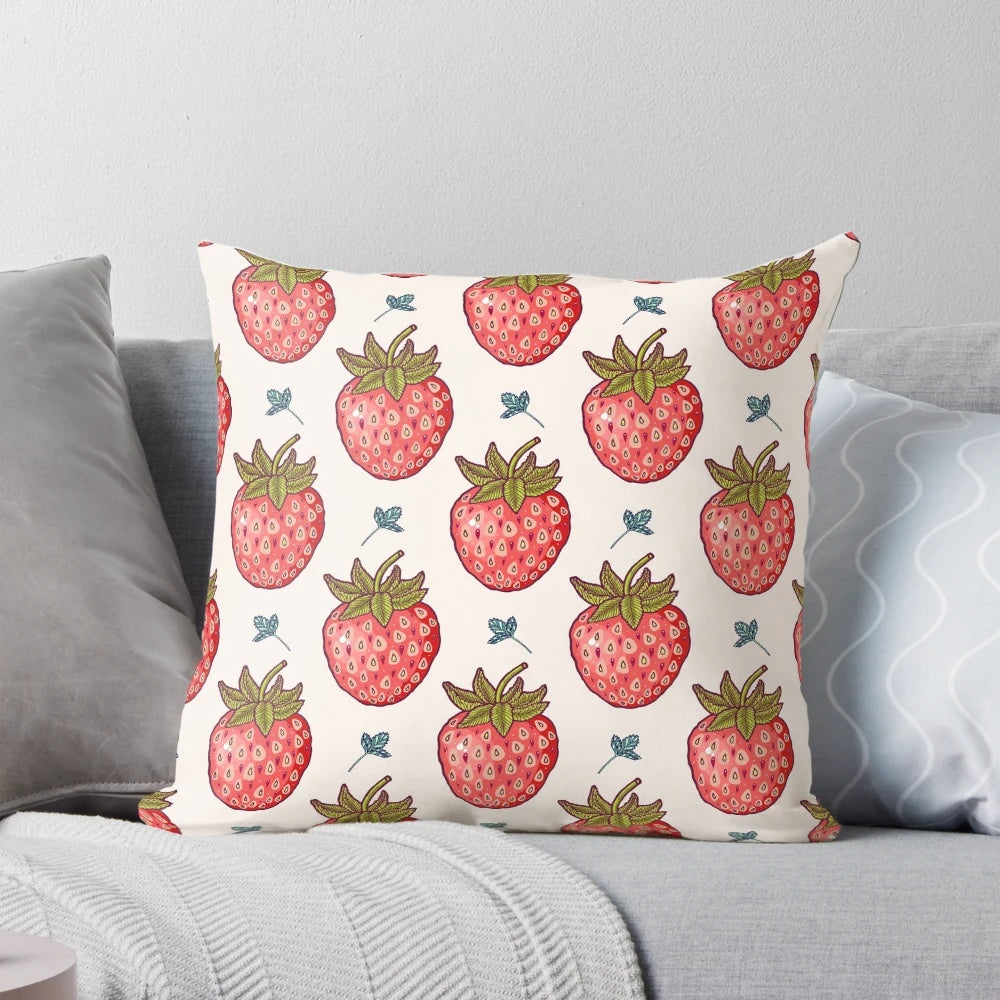Vibrant strawberry-patterned pillow with lush leaves and pastel accents