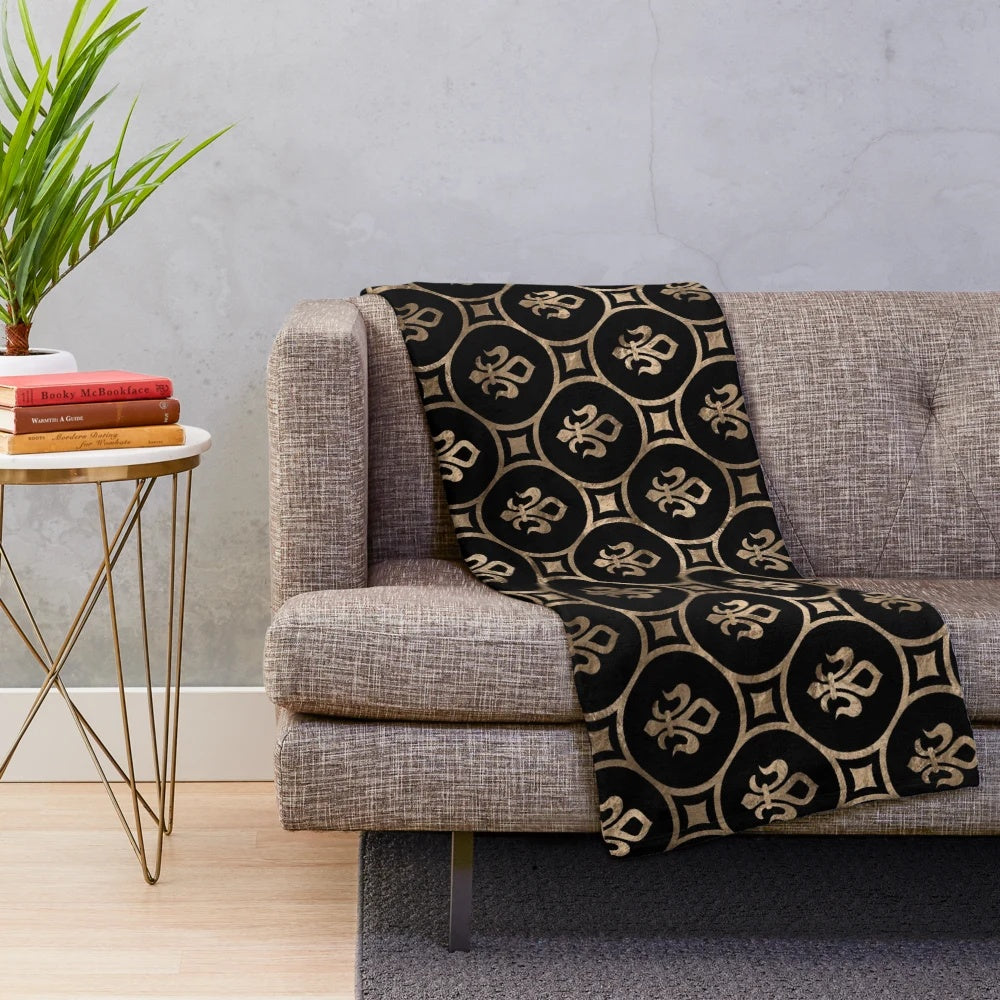 Black and gold plush blanket with a fleur-de-lis pattern