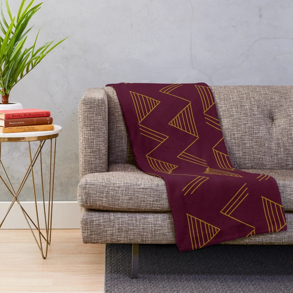 Soft, cozy plush blanket with a modern gold geometric pattern in jewel-toned colors
